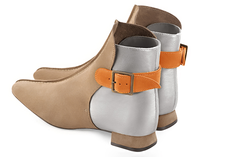 Tan beige, light silver and apricot orange women's ankle boots with buckles at the back. Square toe. Flat flare heels. Rear view - Florence KOOIJMAN